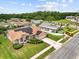 Aerial view of a home with solar panels, lush landscaping, and a well-maintained lawn at 5405 El Cerro Dr, New Port Richey, FL 34655