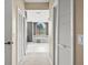 Hallway view of bathroom with tub and tiled surround at 5405 El Cerro Dr, New Port Richey, FL 34655