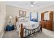 Cozy bedroom featuring an inviting bed with a floral pattern and traditional furniture at 5405 El Cerro Dr, New Port Richey, FL 34655