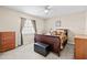 Bedroom featuring a comfortable bed, window views, and matching wooden dressers at 5405 El Cerro Dr, New Port Richey, FL 34655
