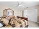 Comfortable bedroom with plush bedding, wooden dresser, and closet with white sliding doors at 5405 El Cerro Dr, New Port Richey, FL 34655
