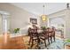 Traditional dining room featuring hardwood floors, an elegant chandelier, and a large window at 5405 El Cerro Dr, New Port Richey, FL 34655