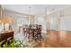 Inviting dining room with hardwood floors, classic furniture, and a large arched window at 5405 El Cerro Dr, New Port Richey, FL 34655