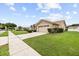 Well-manicured lawn and landscaping highlight this charming single-story home with an attached two-car garage at 5405 El Cerro Dr, New Port Richey, FL 34655