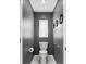 Compact half bathroom with dark grey walls and simple fixtures at 5405 El Cerro Dr, New Port Richey, FL 34655