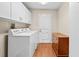 Clean laundry room with washer, dryer, and storage cabinets at 5405 El Cerro Dr, New Port Richey, FL 34655