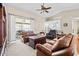 Bright living room with plush carpet, large windows, and comfortable seating at 5405 El Cerro Dr, New Port Richey, FL 34655
