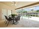 Inviting screened patio with outdoor dining set overlooking the refreshing pool area at 5405 El Cerro Dr, New Port Richey, FL 34655