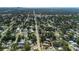 Wonderful aerial of home surrounded by mature trees and lush landscaping featuring the city in the distance at 5413 15Th Ave S, Gulfport, FL 33707