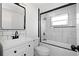 Updated bathroom with white vanity, black fixtures, subway tile backsplash, and shower with glass door at 5413 15Th Ave S, Gulfport, FL 33707