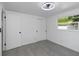 Bright bedroom features light gray flooring, a modern ceiling fan, and natural light from the window at 5413 15Th Ave S, Gulfport, FL 33707