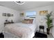 Bright bedroom features a comfortable bed, stylish decor, and soothing natural light at 5413 15Th Ave S, Gulfport, FL 33707