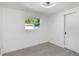 Minimalist bedroom with light grey flooring, a closet, and natural light from a window at 5413 15Th Ave S, Gulfport, FL 33707