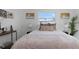 Cozy bedroom featuring neutral bedding, decorative pillows, side tables, and modern art pieces at 5413 15Th Ave S, Gulfport, FL 33707