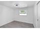 Bright, minimalist bedroom with light grey flooring, modern lighting, and closet at 5413 15Th Ave S, Gulfport, FL 33707