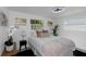 Charming bedroom featuring neutral decor, decorative pillows, large windows, and modern ceiling fan at 5413 15Th Ave S, Gulfport, FL 33707