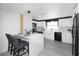 Bright modern kitchen with white cabinets, black appliances, and subway tile backsplash at 5413 15Th Ave S, Gulfport, FL 33707
