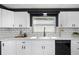 Bright kitchen features white cabinets, subway tile backsplash, modern black hardware, and stainless steel appliances at 5413 15Th Ave S, Gulfport, FL 33707