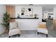 Bright living room with modern decor, light gray laminate floors, and plenty of seating at 5413 15Th Ave S, Gulfport, FL 33707