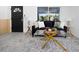Bright living room with modern decor, a large window, and light gray laminate floors at 5413 15Th Ave S, Gulfport, FL 33707