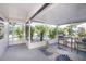 Cozy screened patio featuring comfortable seating and a view of the landscaped yard at 5413 15Th Ave S, Gulfport, FL 33707
