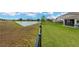 The lawn has a view of a beautiful lake and a fenced in yard at 5492 Summer Sunset Dr, Apollo Beach, FL 33572