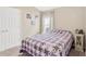 This bedroom features a window and a white closet door, decorated with three colorful pieces of art at 5492 Summer Sunset Dr, Apollo Beach, FL 33572