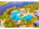 Aerial view of a resort-style community pool featuring a slide and plenty of lounge chairs at 5492 Summer Sunset Dr, Apollo Beach, FL 33572