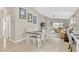 Open concept dining area featuring modern decor, neutral walls, and an open floorplan to the living room at 5492 Summer Sunset Dr, Apollo Beach, FL 33572