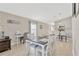 An open dining area features a table for six, light colored flooring, and flows into the kitchen at 5492 Summer Sunset Dr, Apollo Beach, FL 33572