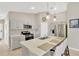 Modern kitchen features stainless steel appliances, a center island with bar seating, and neutral cabinets at 5492 Summer Sunset Dr, Apollo Beach, FL 33572