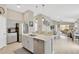 The kitchen features stainless steel appliances, a center island with seating, and is open to the dining and living area at 5492 Summer Sunset Dr, Apollo Beach, FL 33572