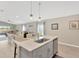 Bright open kitchen with an island and seating, stainless steel appliances, and is open to the dining and living area at 5492 Summer Sunset Dr, Apollo Beach, FL 33572