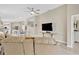 Cozy living room with a ceiling fan, neutral paint, and an open floor plan to the kitchen at 5492 Summer Sunset Dr, Apollo Beach, FL 33572