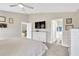 Comfortable bedroom with neutral tones, offering a view into the bathroom and sitting area beyond at 5492 Summer Sunset Dr, Apollo Beach, FL 33572