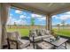 Relax on the patio with stylish outdoor furniture and views of the fenced backyard at 5492 Summer Sunset Dr, Apollo Beach, FL 33572
