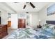 This bedroom has tile flooring, dresser with TV, ceiling fan, and view to the ensuite bathroom at 5915 Sea Ranch Dr # 202, Hudson, FL 34667