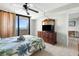 Bedroom with a ceiling fan and a dresser with TV, opens to a balcony overlooking the water at 5915 Sea Ranch Dr # 202, Hudson, FL 34667