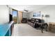 Cozy living room with comfortable seating, ceiling fan, and sliding glass doors leading to a balcony at 5915 Sea Ranch Dr # 202, Hudson, FL 34667