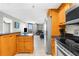 Open-concept living space with a kitchen, and a view of the large windows showcasing natural light at 5915 Sea Ranch Dr # 202, Hudson, FL 34667