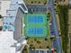Aerial view of two well-maintained tennis courts, perfectly situated near convenient parking and lush landscaping at 5915 Sea Ranch Dr # 202, Hudson, FL 34667