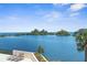Balcony view offers serene blue waters, lush mangroves, and tropical palms. Relax on the patio with this beautiful scene at 5915 Sea Ranch Dr # 202, Hudson, FL 34667