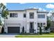Modern two-story home with white siding, black-framed windows, and well-manicured lawn at 620 Marmora Ave, Tampa, FL 33606