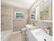 Updated bathroom with double sinks and tiled shower/tub at 6241 Ansley St, Spring Hill, FL 34606
