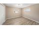 Bedroom with hardwood floors, two windows, and neutral walls at 6241 Ansley St, Spring Hill, FL 34606