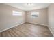 Cozy bedroom featuring hardwood floors, neutral walls, and natural light at 6241 Ansley St, Spring Hill, FL 34606