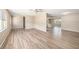 Bright and spacious living room featuring updated flooring and a neutral color palette at 6241 Ansley St, Spring Hill, FL 34606