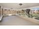 Well-lit screened-in porch with stone accents and a textured floor, perfect for outdoor living at 6241 Ansley St, Spring Hill, FL 34606