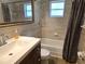 Bathroom featuring a sink, tub, and shower with stylish tilework and modern fixtures for a relaxing experience at 6317 Buster Dr, Tampa, FL 33619