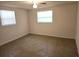 Neutral bedroom with two windows providing natural light and neutral carpet at 6317 Buster Dr, Tampa, FL 33619